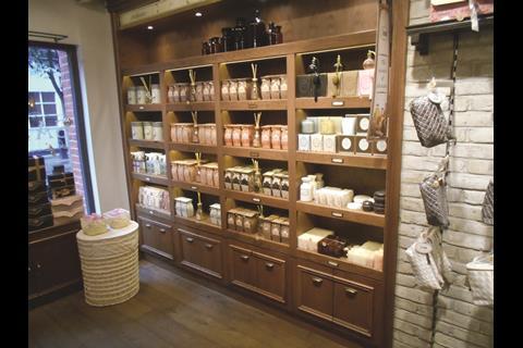Venture inside and it’s a matter of dark wood perimeter shelves, reclaimed oak plank floors and a font-like structure in the mid-shop.